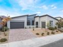 Stunning modern home featuring desert landscaping and a brick driveway at 477 Highview Ridge Ave, Las Vegas, NV 89138