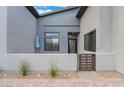 Stylish front porch with a gated entry and desert landscaping at 477 Highview Ridge Ave, Las Vegas, NV 89138
