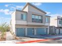 Contemporary two-story home with blue garage doors, modern landscaping, and a paver driveway at 4915 Chidlaw Ave # 2, Las Vegas, NV 89115