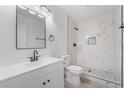 Modern bathroom featuring white vanity, stylish fixtures, and a luxurious tile shower at 4980 Becky Pl, Las Vegas, NV 89120