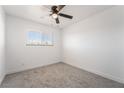 Bright bedroom with neutral carpet, a ceiling fan, and natural light from the window at 4980 Becky Pl, Las Vegas, NV 89120