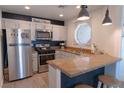 Charming kitchen featuring stainless appliances, granite countertops, and modern light fixtures at 5040 S Rainbow Blvd # 201, Las Vegas, NV 89118