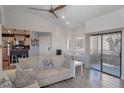 Bright living room with hardwood floors, neutral tones, and a sliding glass door to the patio at 5040 S Rainbow Blvd # 201, Las Vegas, NV 89118