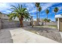 Spacious backyard with a concrete patio and mature landscaping, perfect for entertaining at 5065 Atherton St, Las Vegas, NV 89120