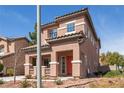 A charming two-story house with a terracotta-tiled roof and colorful shutters, complemented by desert landscaping at 5932 Lamotte Ave, Las Vegas, NV 89141