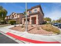 A charming two-story house with a terracotta-tiled roof and colorful shutters, complemented by desert landscaping at 5932 Lamotte Ave, Las Vegas, NV 89141