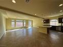 Open-concept living room featuring tile floors and a spacious kitchen at 6093 Crown Palms Ave, Las Vegas, NV 89139