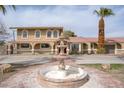 Home exterior with a fountain, palm trees, and arched window accents give the home an inviting curb appeal at 6130 Tara Ave, Las Vegas, NV 89146