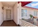 The covered entryway features a tiled floor, secure gate, and outdoor decor at 6325 Miraloma St, Las Vegas, NV 89108
