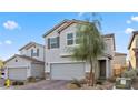 Charming two-story home featuring desert landscaping, a two-car garage, and neutral-toned stucco exterior at 6957 Antequera St, Las Vegas, NV 89149