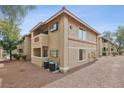 Beige two-story condo building shows a well-maintained exterior with classic architectural details and landscaping at 7200 Pirates Cove Rd # 2089, Las Vegas, NV 89145