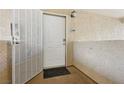 White front door with security screen and welcome mat offers a secure, inviting entrance to the home at 7200 Pirates Cove Rd # 2089, Las Vegas, NV 89145