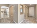 Inviting foyer with tile floors and arched doorways at 7709 Tiny Tortoise St, Las Vegas, NV 89149