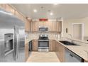 Modern kitchen features stainless steel appliances, granite countertops, and wood cabinetry at 8255 S Las Vegas Blvd # 1907, Las Vegas, NV 89123