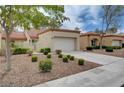 Exterior of single-Gathering home with a two car garage, a manicured lawn and desert landscaping at 8657 Prairie Hill Dr, Las Vegas, NV 89134
