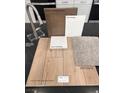 Selection of interior finishes featuring wood-look luxury vinyl plank, neutral carpet, quartz countertop, and sleek stainless faucet at 9241 Soho Sky Ct, Las Vegas, NV 89148