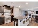 Modern kitchen featuring dark cabinetry, granite countertops, stainless steel appliances and a large island at 1045 Spotted Saddle St, Henderson, NV 89015