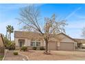 Charming single-story home featuring desert landscaping and a spacious two-car garage at 1077 Las Palmas Entrada Ave, Henderson, NV 89012