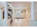 Bright foyer featuring tile flooring, white columns, and a staircase leading to the upper level at 10900 Calcedonian St, Las Vegas, NV 89141