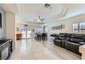 Open-concept living and dining area with recessed lighting and tile flooring, leading to a sliding glass door at 10900 Calcedonian St, Las Vegas, NV 89141