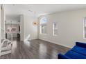 Open-concept living room with lots of natural light and hardwood floors at 11484 Roncat Ct, Las Vegas, NV 89141