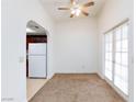 Bright dining area with tile floors leading to kitchen, carpet, a ceiling fan, and exterior access at 1212 Bass Dr # C, Henderson, NV 89014