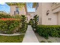 Beautiful home exterior with manicured hedges, colorful plants, and a paved walkway at 1212 Muscato Ct, Las Vegas, NV 89144