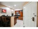 Cozy kitchen featuring a breakfast bar, stainless steel appliances, and sleek black countertops at 135 Harmon Ave # 3220, Las Vegas, NV 89109