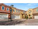 Charming two-story townhome featuring a well-maintained front yard and attached two-car garage at 23 Cerchio Basso, Henderson, NV 89011