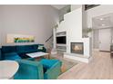 Bright living room with fireplace, plush seating, and soaring ceilings at 23 Cerchio Basso, Henderson, NV 89011