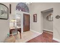 Bright foyer with tile flooring, a decorative mirror, and stylish wooden door at 2508 Palmridge Dr, Las Vegas, NV 89134