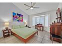 Serene bedroom with tile floors, neutral walls, and a large window for ample natural light at 2608 Saltbush Dr, Las Vegas, NV 89134