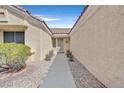 Home's front entrance featuring a sidewalk flanked by decorative rock at 2608 Saltbush Dr, Las Vegas, NV 89134