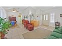 Living room and dining area with tile flooring, white walls, and vaulted ceilings at 2608 Saltbush Dr, Las Vegas, NV 89134