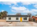 Charming home showcasing a modern exterior with a bright yellow door and gravel landscaping at 2621 Bello Dr, North Las Vegas, NV 89030