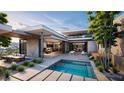 Modern outdoor space featuring a pool, sleek patio and outdoor dining, perfect for entertaining guests at 3 Climbing Canyon Dr, Henderson, NV 89052
