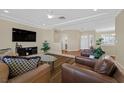 Spacious living room featuring hardwood floors, plush seating, a ceiling fan, and a large TV at 3042 Lake Barkley Rd, Henderson, NV 89052