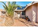 Charming home featuring desert landscaping, solar panels and a cozy sitting bench near the entrance at 3108 Ocotillo Dr, Laughlin, NV 89029