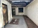 A cozy enclosed patio area with a covered pergola, concrete pavers and a side door at 3422 Pino Cir, Las Vegas, NV 89121