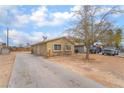 Charming single-story home featuring a long driveway, desert landscaping, and mature trees at 3704 Haddock Ave, North Las Vegas, NV 89030