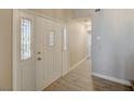 Inviting front door with sidelights and wood-look flooring at 371 Sanctuary Ct, Henderson, NV 89014