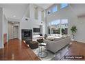 Staged living room boasts high ceilings, fireplace, large windows, and comfortable seating at 3728 White Lion Ln, North Las Vegas, NV 89084