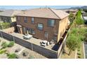 An aerial view of the home's back patio with furniture and privacy wall. Small bushes and trees are also visible at 537 Blanche Ct, Henderson, NV 89052