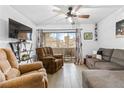 Comfortable living room featuring tile floors, a ceiling fan, and a sliding glass door to the outside at 5710 E Tropicana Ave # 1166, Las Vegas, NV 89122