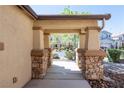 Covered porch with stone-clad pillars and a view of the neighborhood at 6036 Sierra Lakes St, North Las Vegas, NV 89031