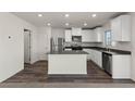 Modern kitchen with stainless steel appliances, a center island, and dark countertops at 6215 Blood Lily Ave, Las Vegas, NV 89122