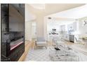 Open living space with a fireplace, modern seating, and seamless flow into the kitchen and dining area at 6628 Silver Penny Ave, Las Vegas, NV 89108