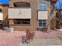 View of the building exterior with red rock landscaping, windows and balcony at 9000 Las Vegas Blvd # 1097, Las Vegas, NV 89123