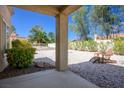 Relaxing backyard space featuring desert landscaping, a covered patio, and a charming Adirondack chair at 9028 Firebird Dr, Las Vegas, NV 89134