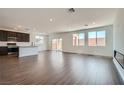 Bright, open-concept living space features hardwood floors, a fireplace, and access to a kitchen and backyard at 9825 Lost Horse Ave, Las Vegas, NV 89178